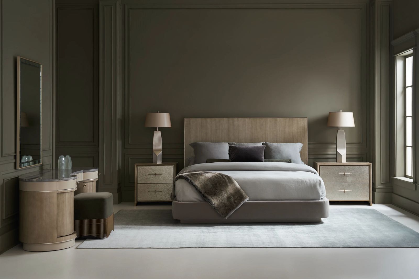 Primary bedroom with upholstered bed, twin nightstands, and mirrored chests